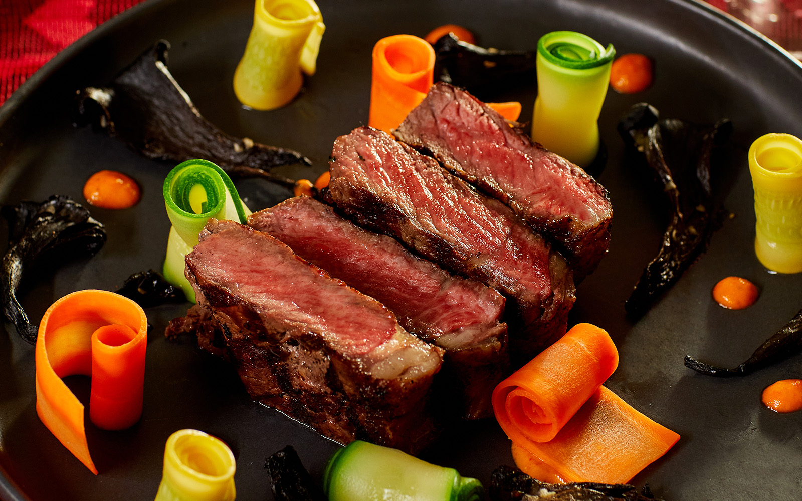 Plated steak and rolled veggies