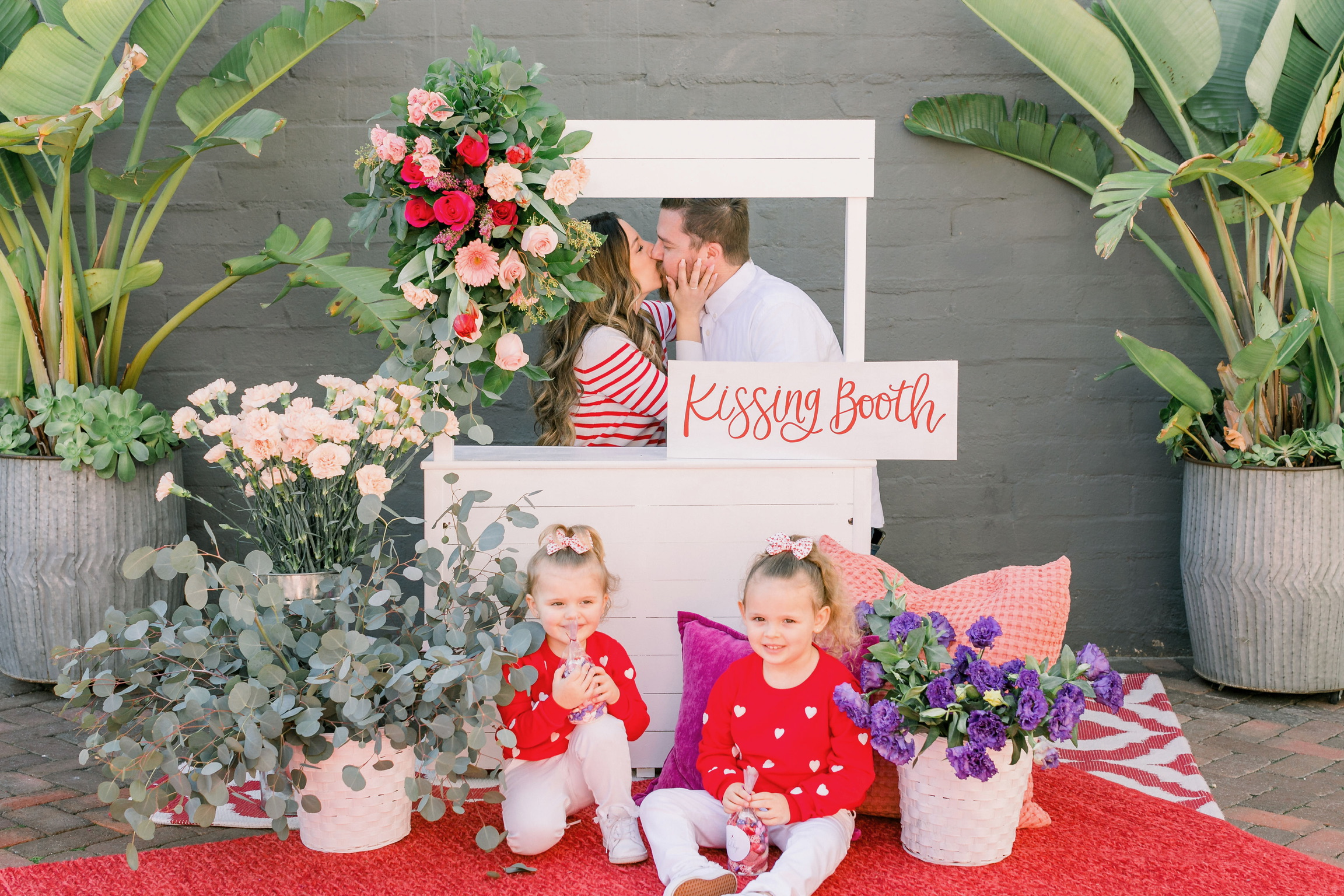 photo of a couple at a kissing booth